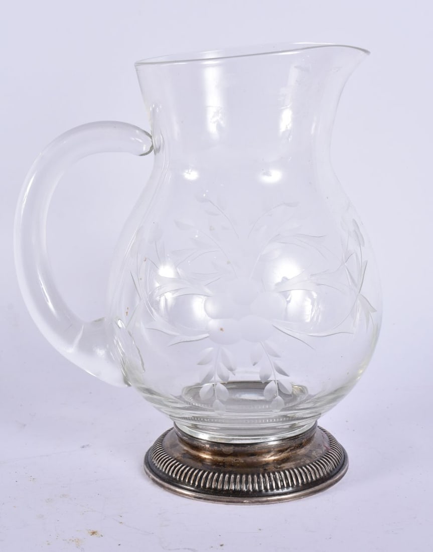A SILVER MOUNTED GLASS JUG. 17 cm high. (1 of 5)