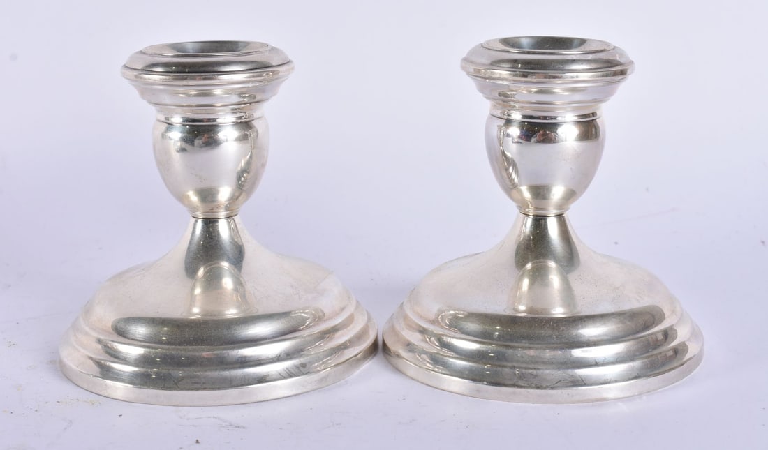 A PAIR OF SILVER CANDLESTICKS. 800 grams overall. 9.75 cm high. (1 of 5)