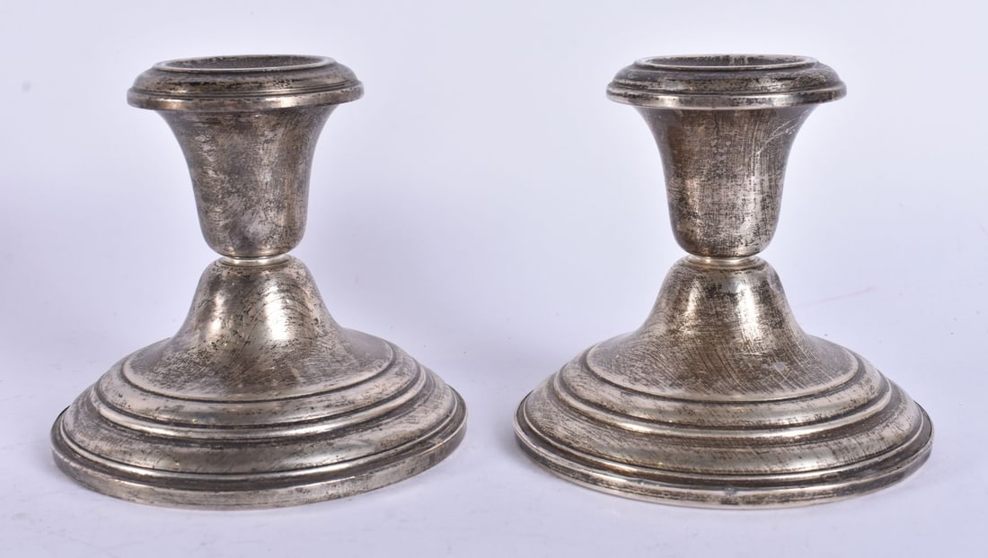A PAIR OF SILVER CANDLESTICKS. 700 grams overall. 11 cm high. (1 of 5)