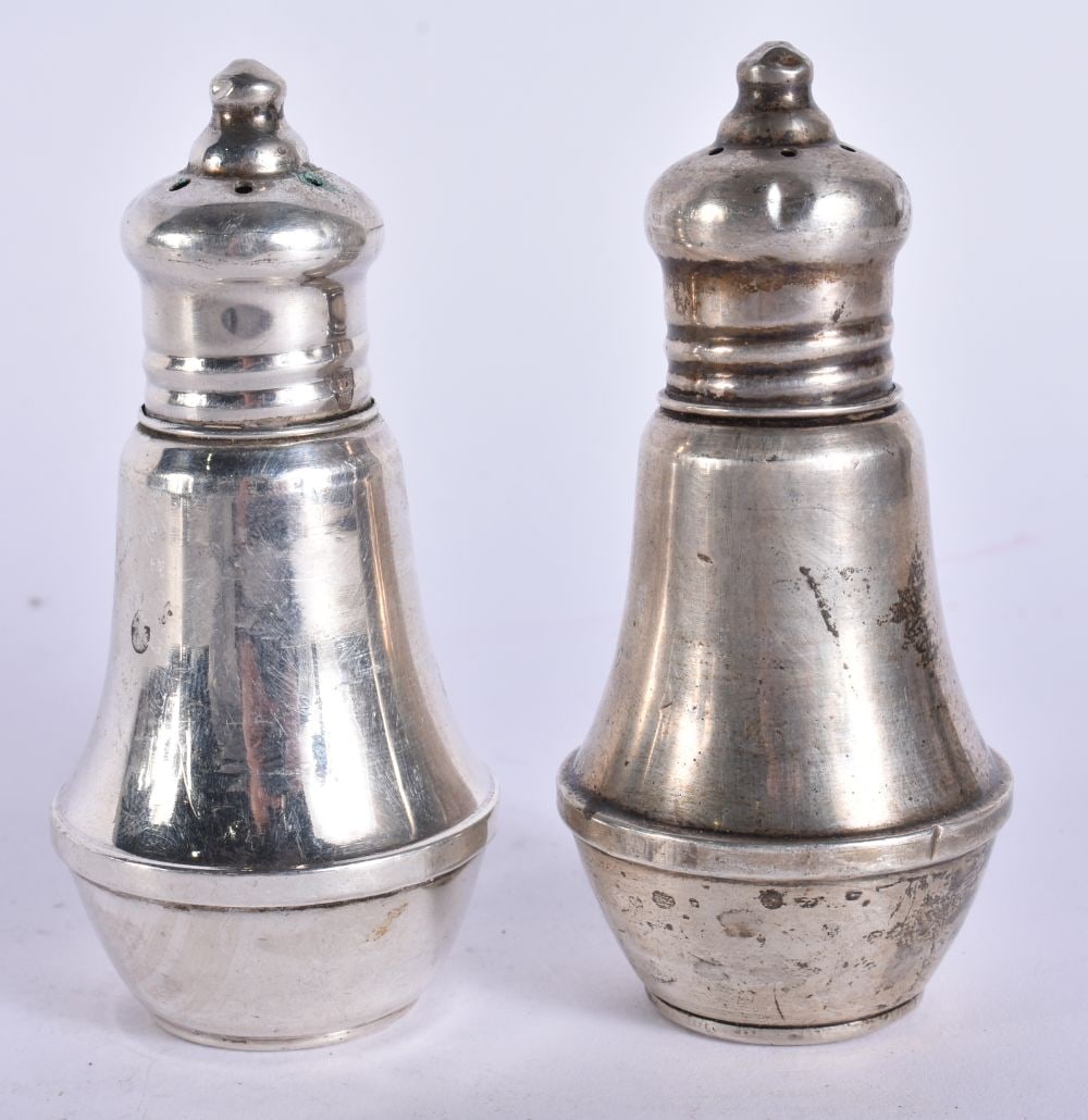 A PAIR OF SILVER CONDIMENTS. 144 grams overall. 8 cm high. (1 of 5)