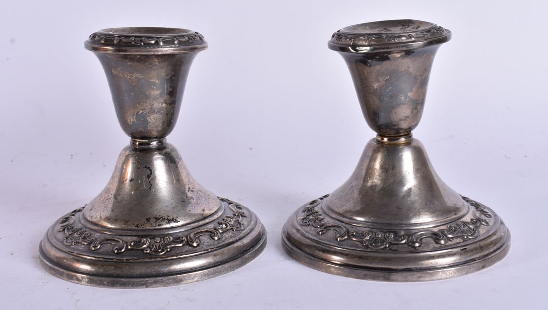 A PAIR OF SILVER CANDLESTICKS. 500 grams overall. 10 cm high. (1 of 5)