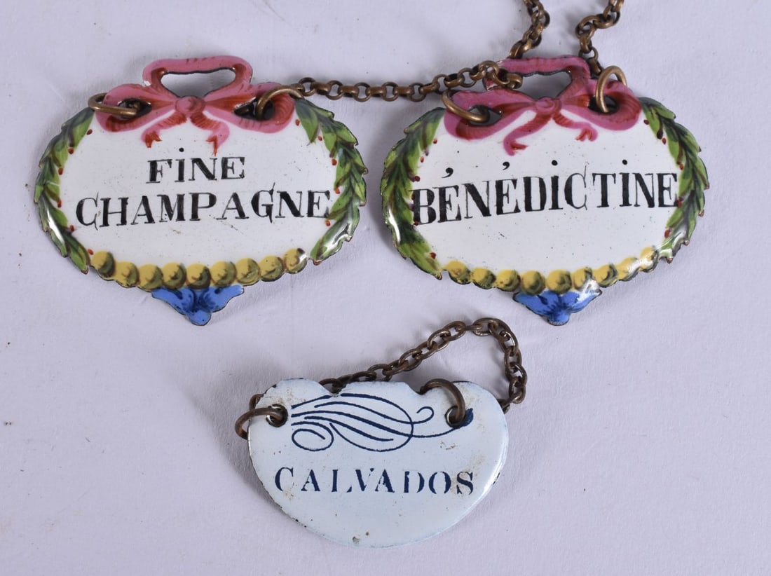 THREE ANTIQUE ENAMEL WINE BOTTLE LABELS. 4.5 cm wide. (3): THREE ANTIQUE ENAMEL WINE BOTTLE LABELS. 4.5 cm wide. (3)