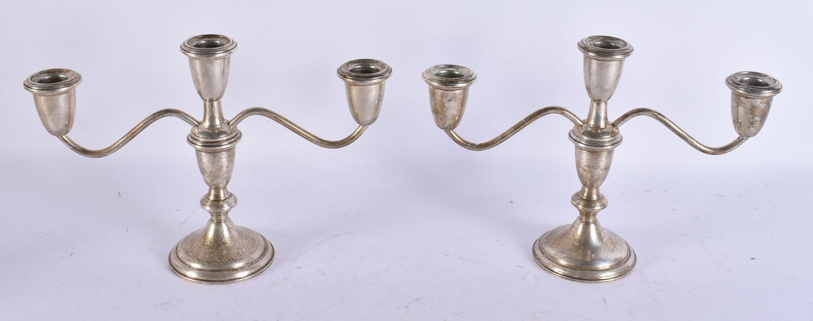 A PAIR OF SILVER CANDELABRA. 1112 grams overall. 18 cm x 24 cm. (1 of 4)