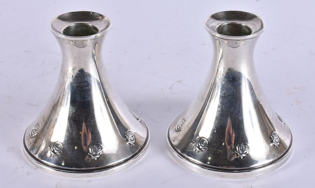 A PAIR OF SILVER CANDLESTICKS. 642 grams overall. 9 cm high. (1 of 3)