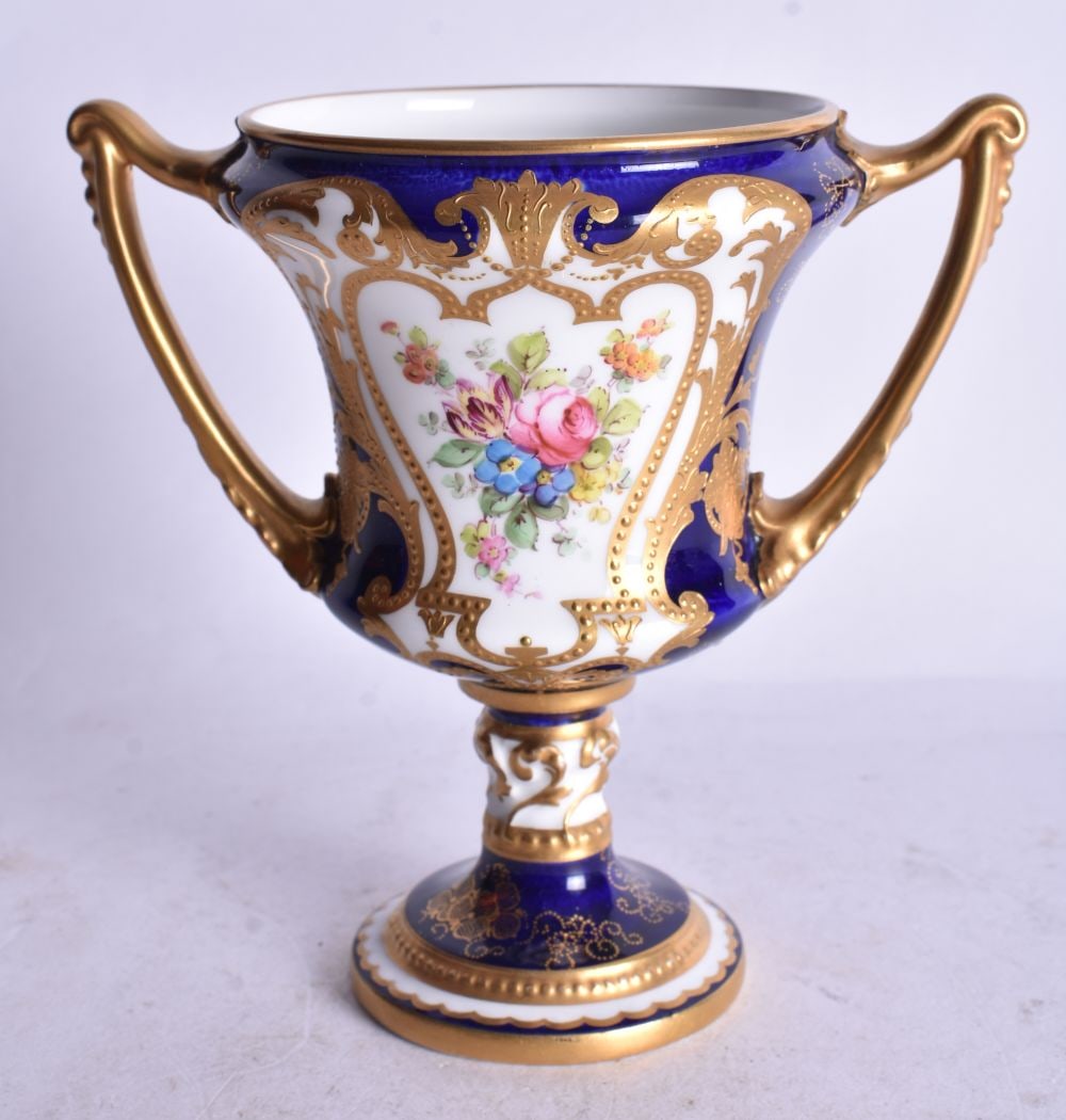 Royal Crown Derby two handle vase painted with blue and gilt ground and a large bouquet of flowers, (1 of 3)