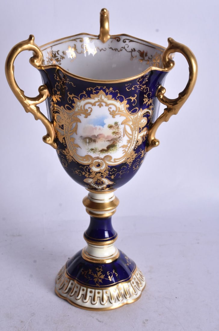 Early 20th century Coalport three handled pedestal vase painted with a Scottish loch scene green mar: Early 20th century Coalport three handled pedestal vase painted with a Scottish loch scene green mark. 17cm height