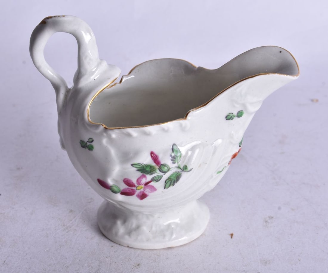 18th century Worcester moulded ewer painted with coloured flowers under a lamprey handle. 8,5cm high (1 of 4)
