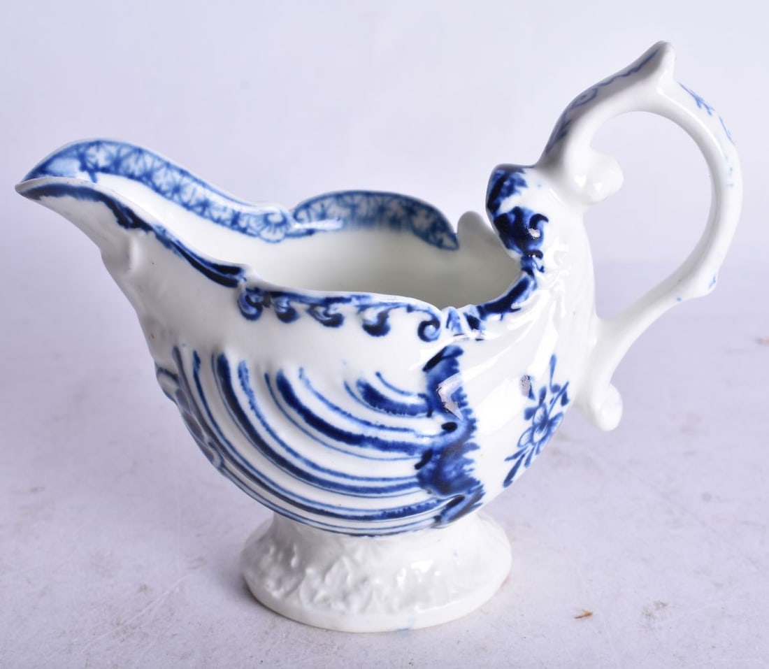 18th century Derby moulded ewer painted with in blue and white under a handle with thumbrest. 8cm hi (1 of 3)