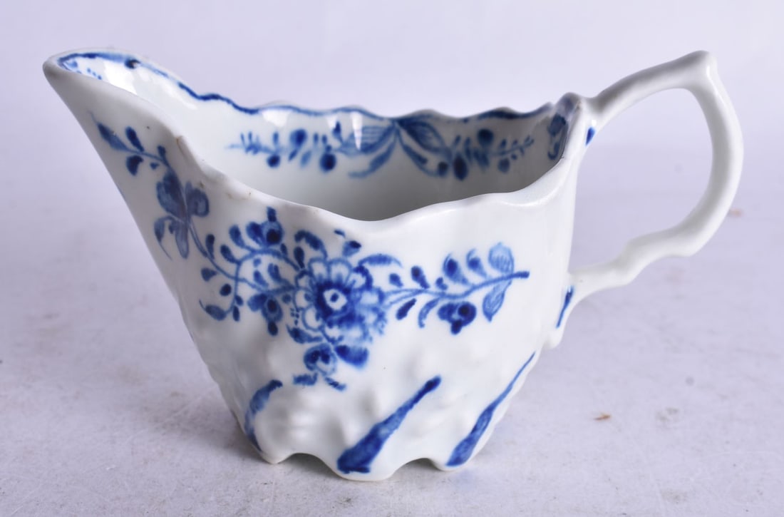 18th century Lowestoft low Chelsea ewer moulded and painted with a trailing flower on each side. 6cm: 18th century Lowestoft low Chelsea ewer moulded and painted with a trailing flower on each side. 6cm