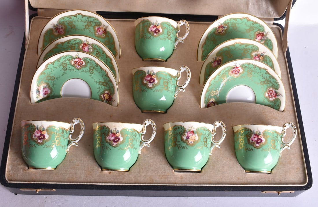 Royal Worcester boxed coffee set painted with flowers on a lime green ground date mark 1936, 6cm hig (1 of 3)