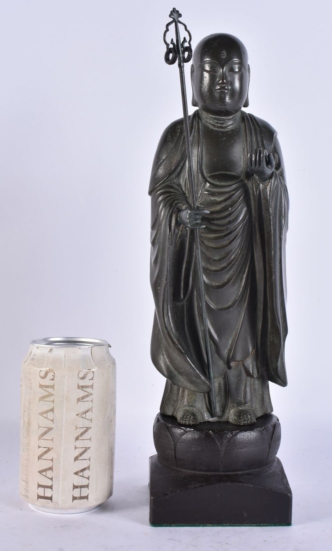 A LARGE 18TH CENTURY JAPANESE EDO PERIOD BRONZE JIZO BOZATSU modelled holding a staff and a fruit in: A LARGE 18TH CENTURY JAPANESE EDO PERIOD BRONZE JIZO BOZATSU modelled holding a staff and a fruit in the other hand, bearing Nijon-Ji, Kyonan temple inscription to the reverse, upon a later base. Bron