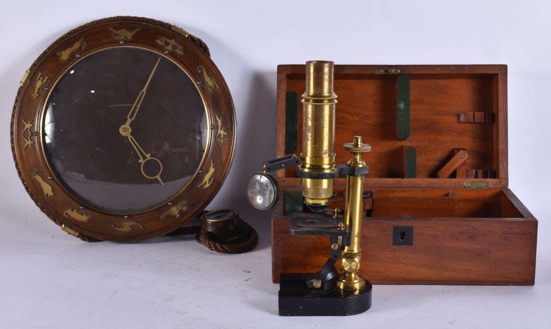 A VINTAGE CLOCK together with a microscope. (2) (1 of 3)