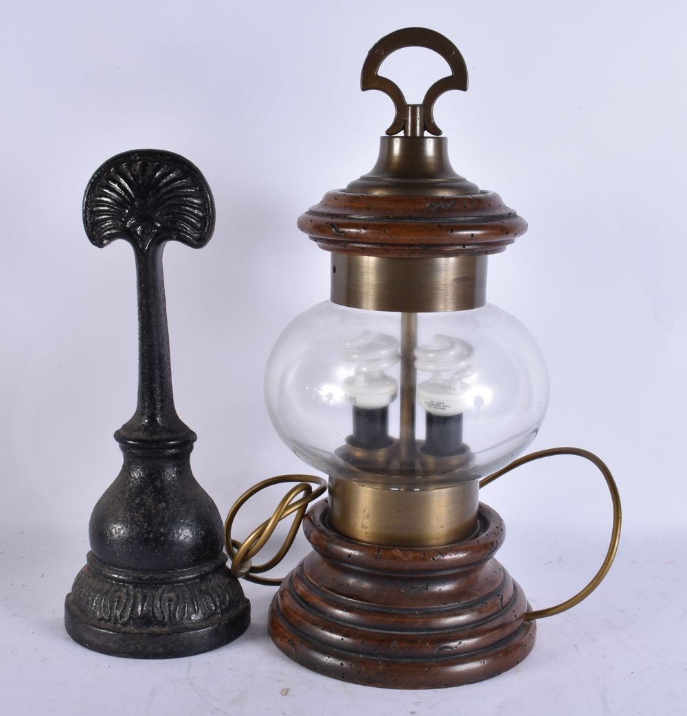 A CAST IRON DOOR STOP together with lamp. Largest 47 cm high. (2) (1 of 2)