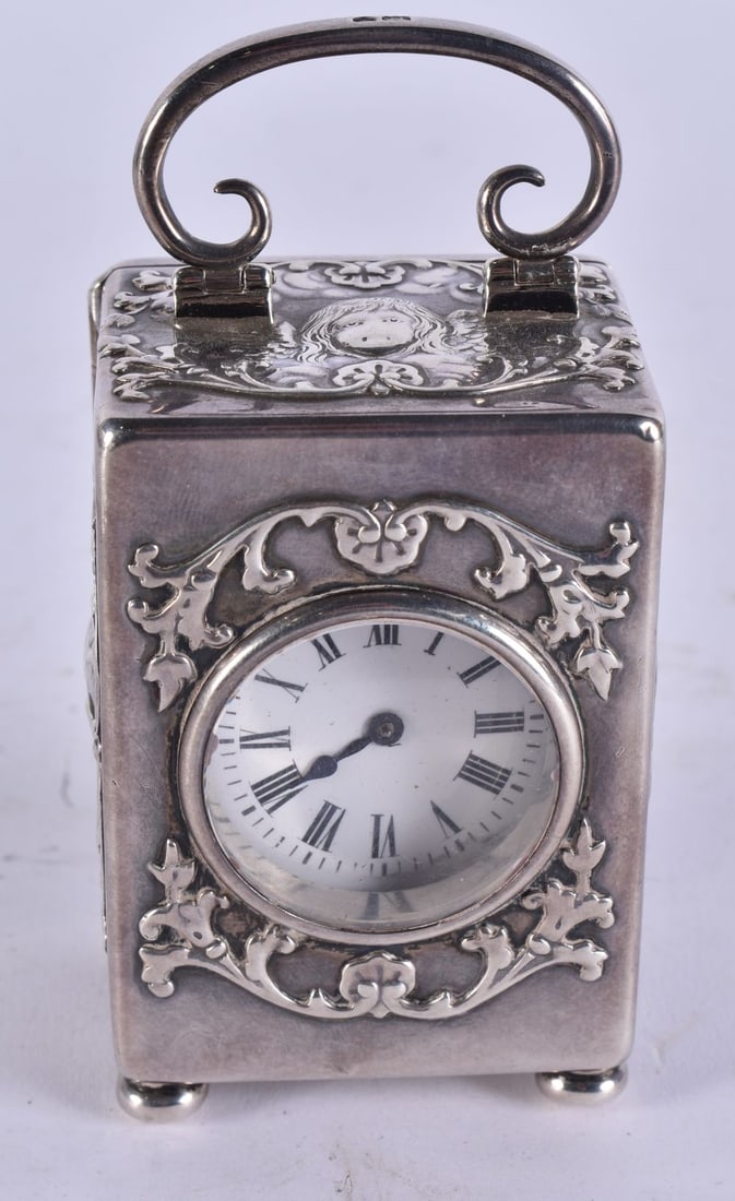 AN ANTIQUE WILLIAM COMYNS SILVER CARRIAGE CLOCK. 380 grams overall. 10 cm high inc handle. (1 of 5)