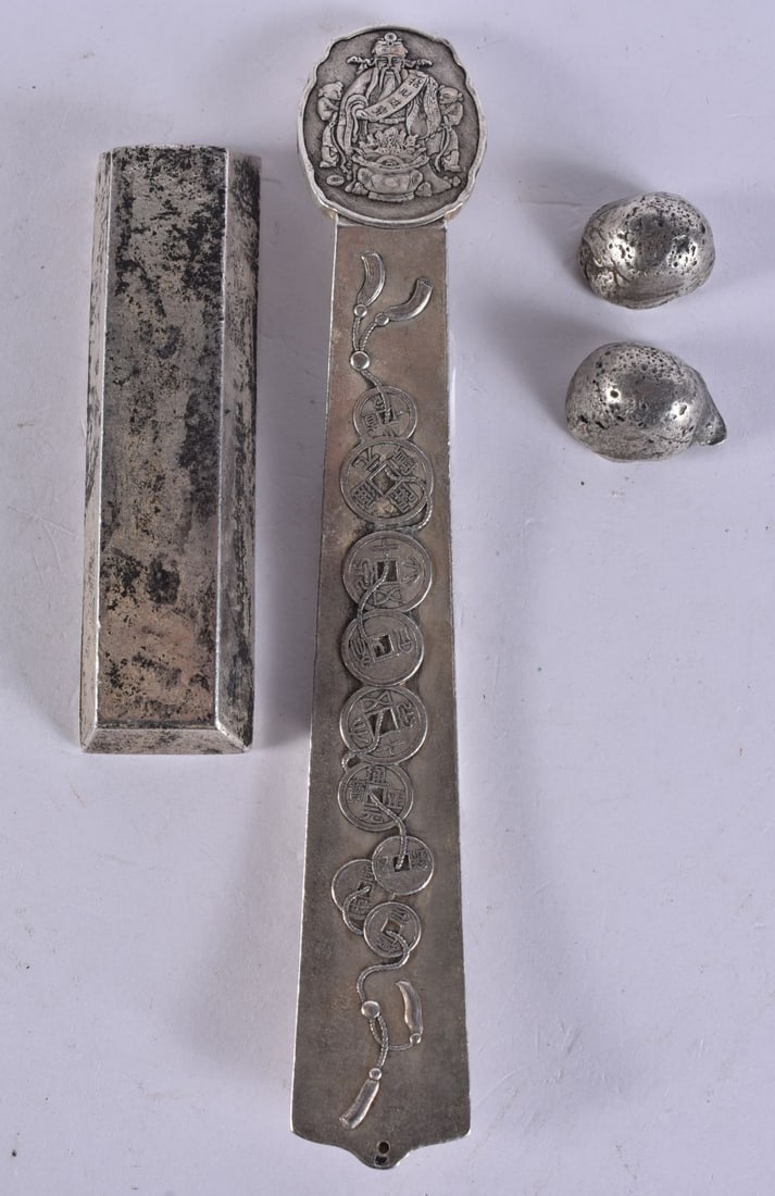 A CHINESE WHITE METAL INGOT together with two others and a scroll weight. 408 grams. Largest 17 cm l (1 of 4)