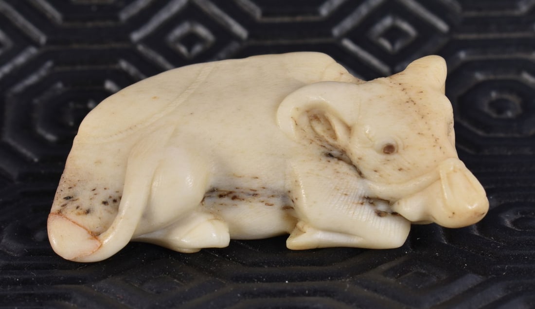 A 19TH CENTURY JAPANESE MEIJI PERIOD CARVED STAG ANTLER NETSUKE formed as a bullock. 5 cm x 2.5 cm. (1 of 6)