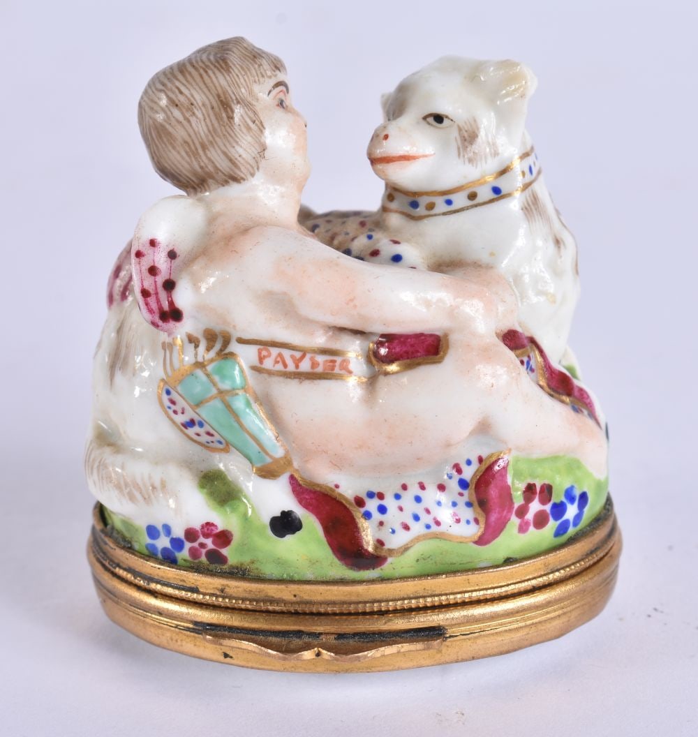 A 19TH CENTURY FRENCH PORCELAIN PILL BOX formed as a cherub with sheep. 5 cm x 5.5 cm. (1 of 6)