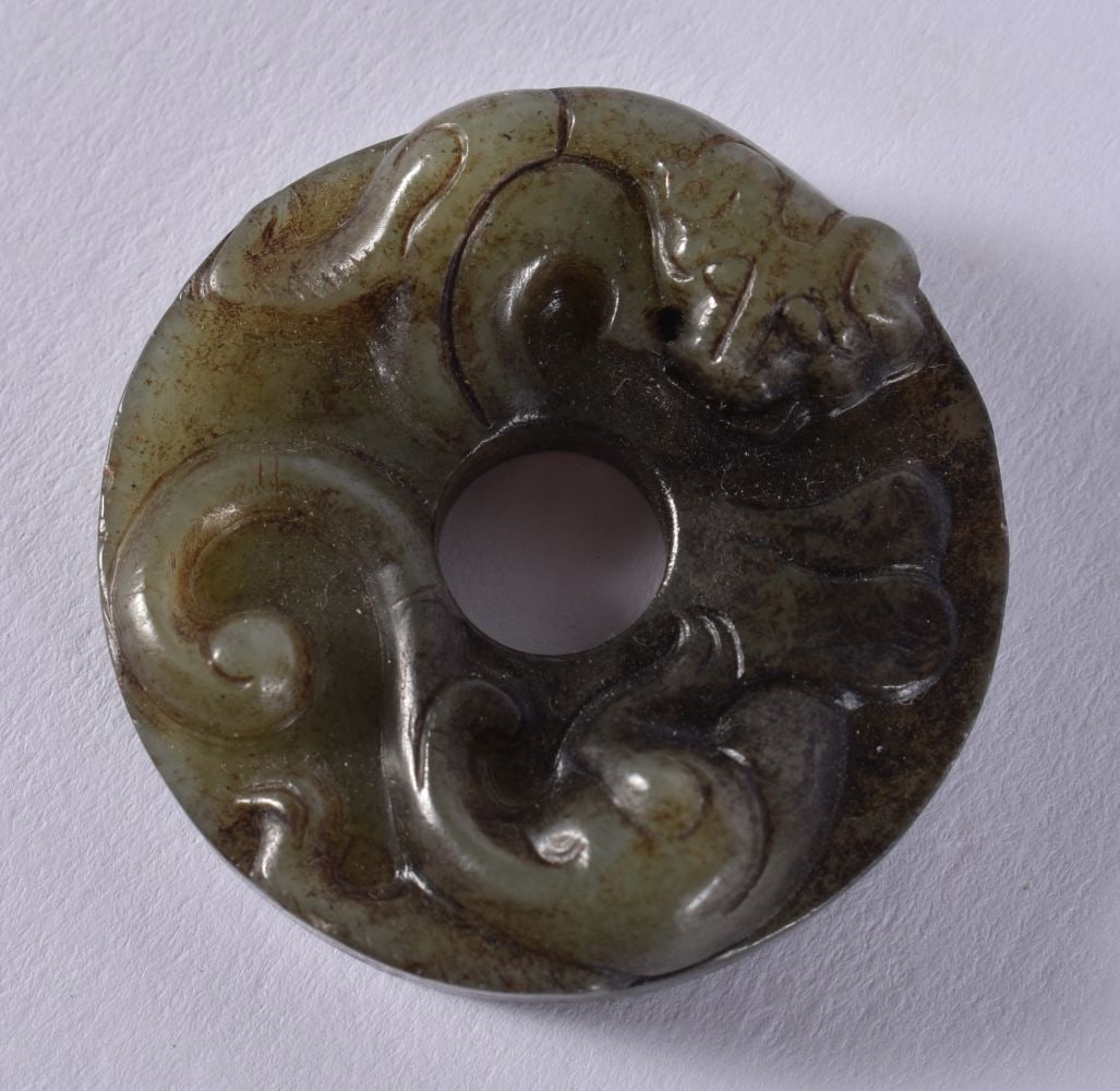 A CHINESE JADE ROUNDEL. 16 grams. 3.5 cm wide. (1 of 2)