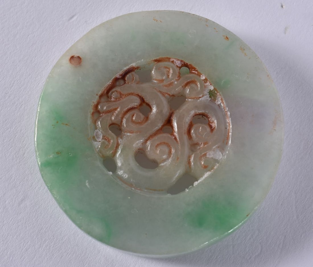 A CHINESE JADE ROUNDEL. 50 grams. 5.25 cm wide. (1 of 3)