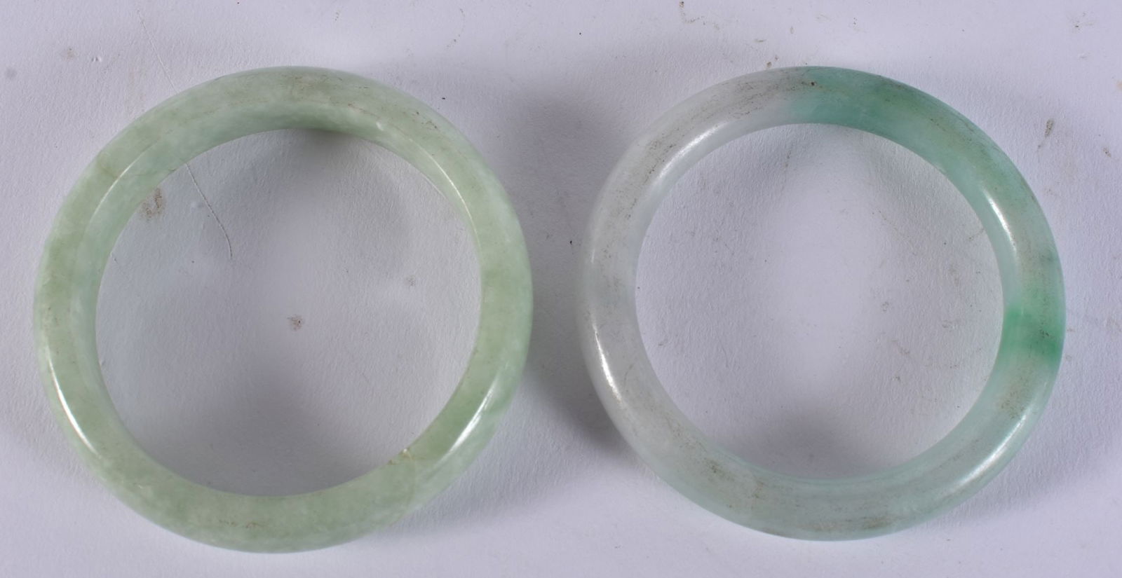 TWO CHINESE JADEITE BANGLES. 120 grams. 5.75 cm wide. (2) (1 of 3)