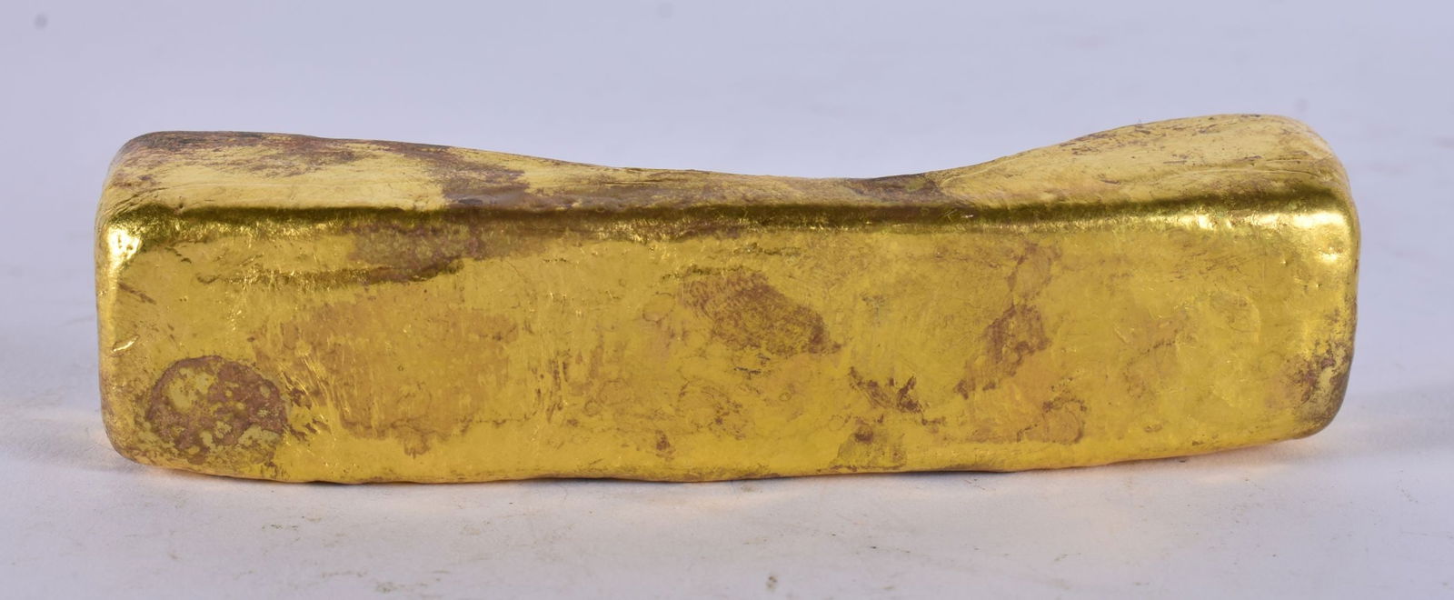 A CHINESE YELLOW METAL SCROLL WEIGHT. 298 grams. 12 cm long.: A CHINESE YELLOW METAL SCROLL WEIGHT. 298 grams. 12 cm long.