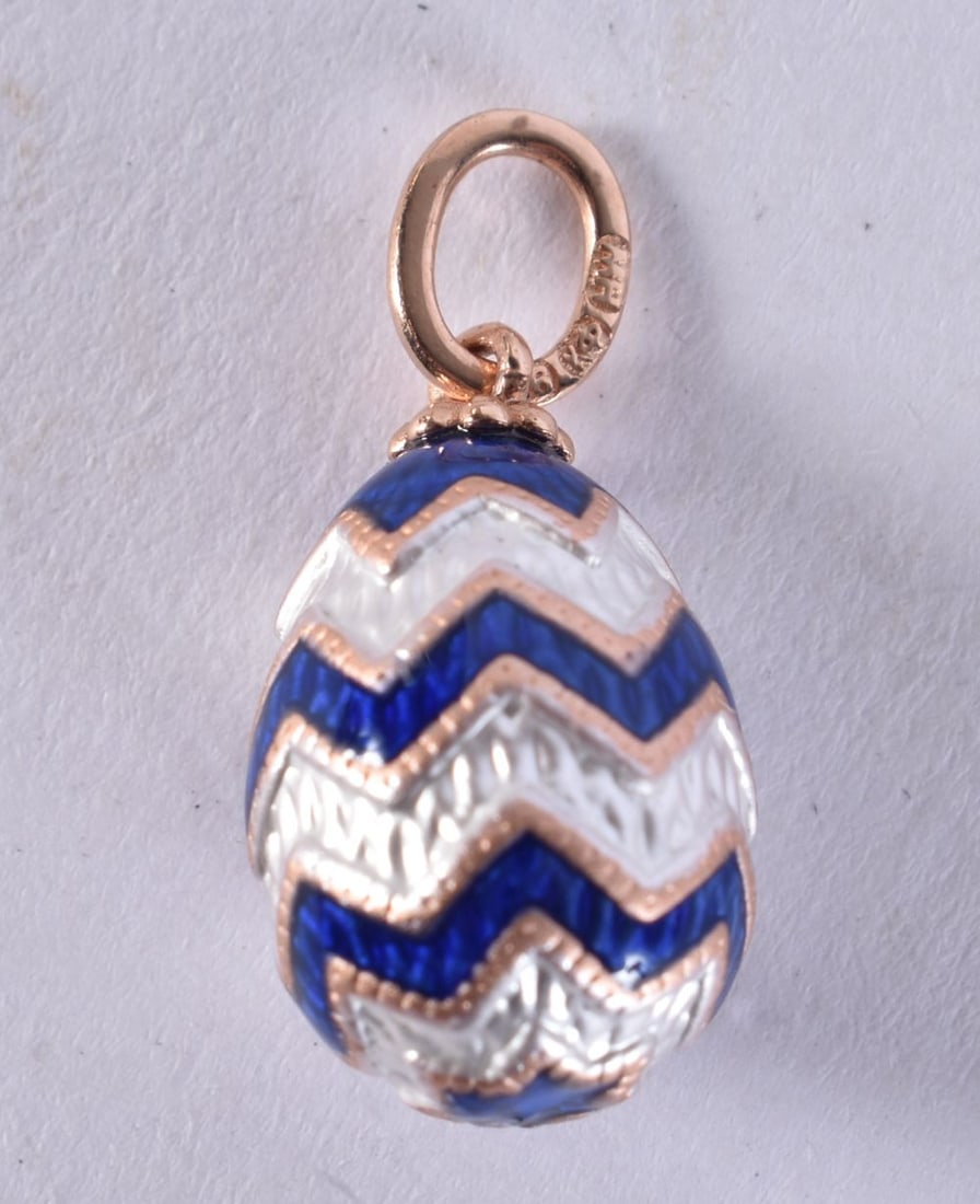 A 14CT GOLD EGG PENDANT. 2.6 grams. 2.25 cm x 1.25 cm. (1 of 3)