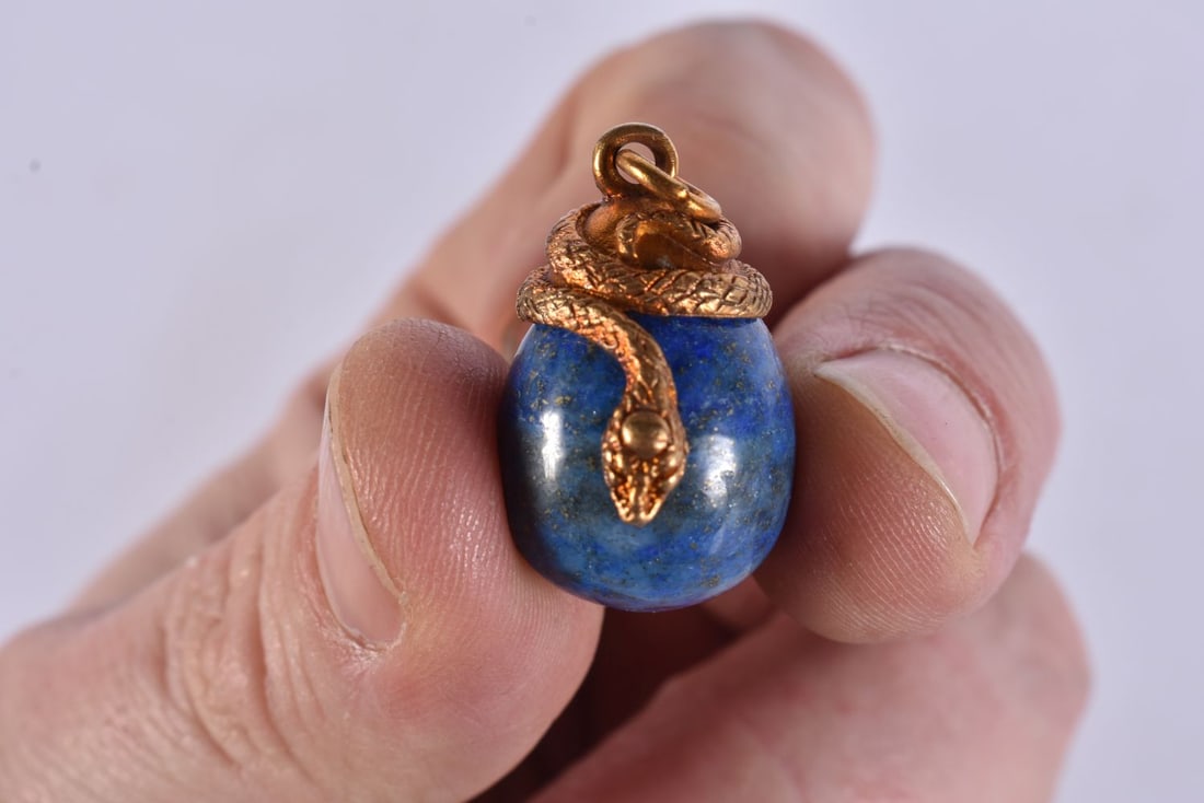 A SILVER GILT AND LAPIS LAZULI EGG PENDANT. 13.8 grams. 3 cm x 2 cm. (1 of 3)