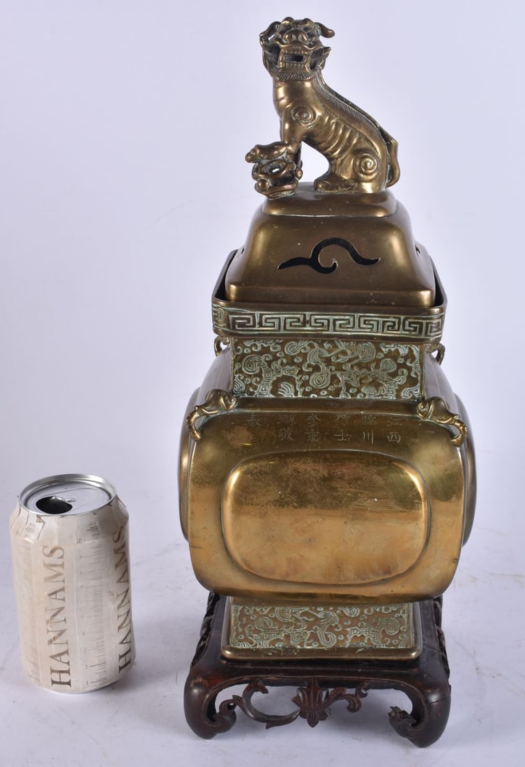 A CHINESE QING DYNASTY BRONZE CENSER AND COVER bearing inscription to base. 36 cm high.: A CHINESE QING DYNASTY BRONZE CENSER AND COVER bearing inscription to base. 36 cm high.