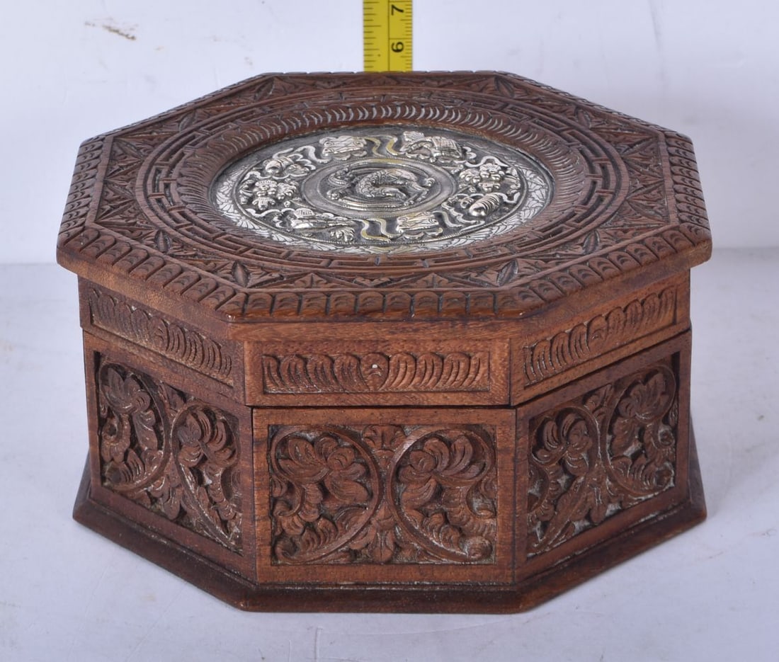 A carved wood Anglo Indian lidded box with a white metal embossed ventral Medallion possibly silver: A carved wood Anglo Indian lidded box with a white metal embossed ventral Medallion possibly silver 7 x 14cm