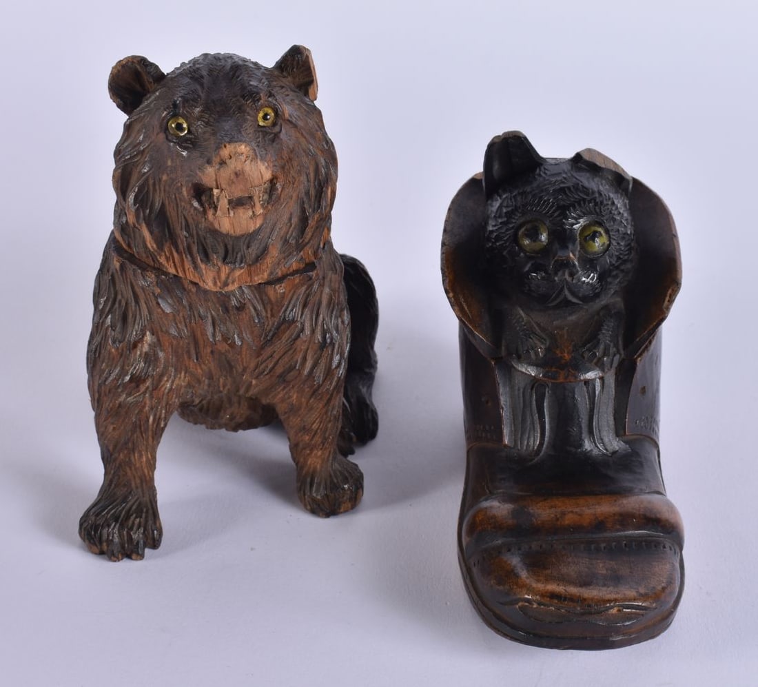 TWO LATE 19TH CENTURY BAVARIAN BLACK FOREST WOOD INKWELLS modelled as a bear & a cat within a shoe.: TWO LATE 19TH CENTURY BAVARIAN BLACK FOREST WOOD INKWELLS modelled as a bear & a cat within a shoe. Largest 15 cm x 9 cm.