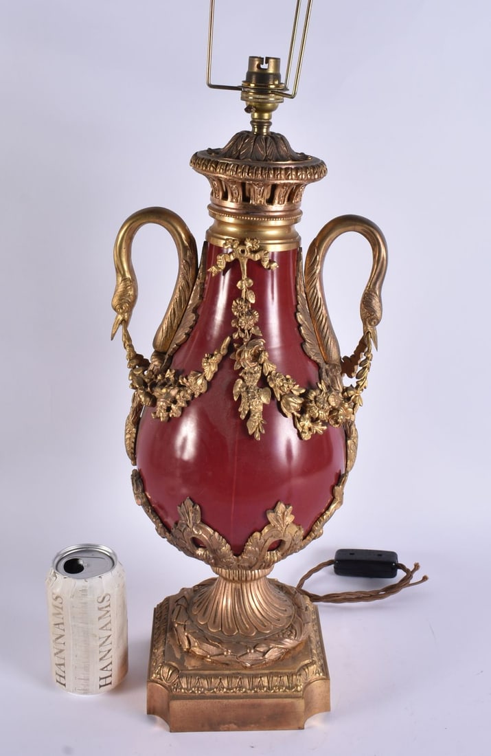 A LARGE ANTIQUE FRENCH POTTERY AND GILT BRONZE LAMP overlaid with foliage and vines. 67 cm high.: A LARGE ANTIQUE FRENCH POTTERY AND GILT BRONZE LAMP overlaid with foliage and vines. 67 cm high.