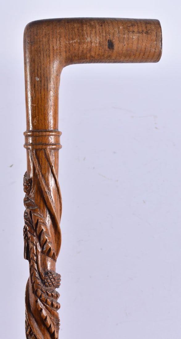 A SCOTTISH FOLK ART THISTLE WOOD WALKING CANE. 89 cm long.: A SCOTTISH FOLK ART THISTLE WOOD WALKING CANE. 89 cm long.