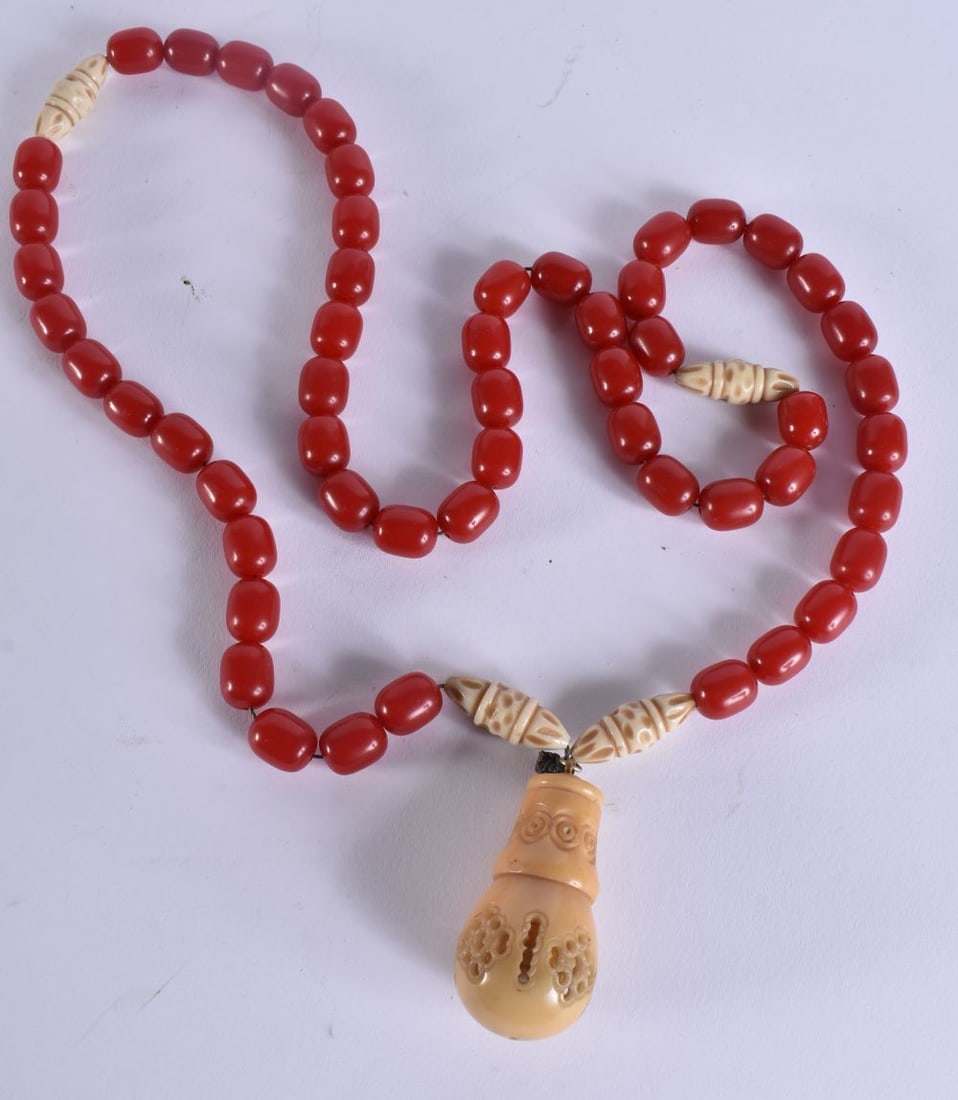 A VINTAGE CHERRY BEAD AND TAGUA NUT TRIBAL NECKLACE. 100 cm long.: A VINTAGE CHERRY BEAD AND TAGUA NUT TRIBAL NECKLACE. 100 cm long.