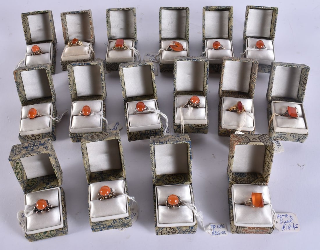 SIXTEEN CHINESE SILVER AND AGATE RINGS in various forms and sizes. (16): SIXTEEN CHINESE SILVER AND AGATE RINGS in various forms and sizes. (16)