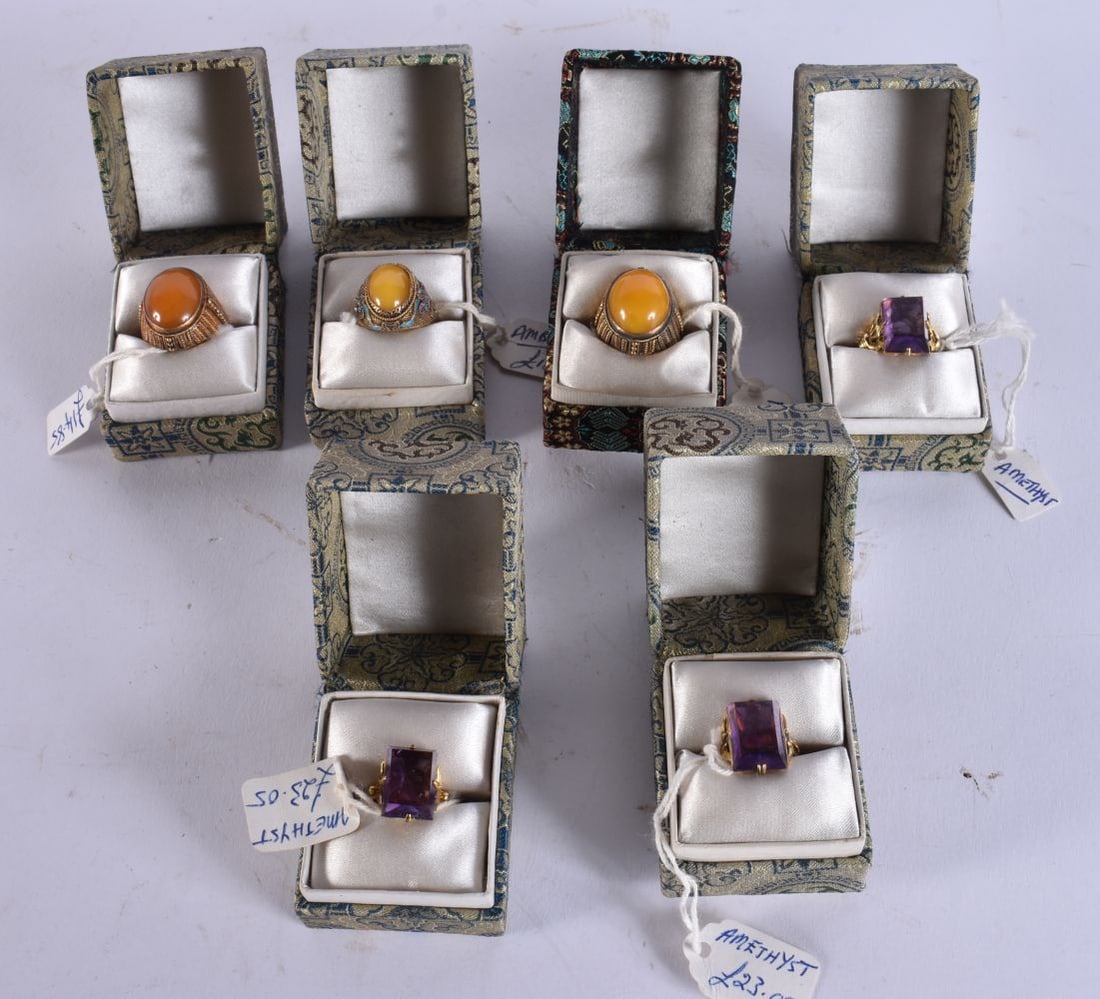 THREE CHINESE SILVER AND AMBER RINGS together with three silver and amethyst rings. (6): THREE CHINESE SILVER AND AMBER RINGS together with three silver and amethyst rings. (6)