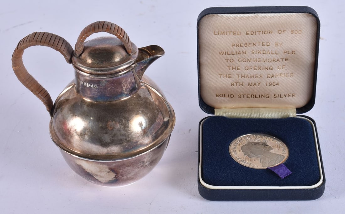 A SILVER PROOF COIN together with a silver jug. 136 grams. (2): A SILVER PROOF COIN together with a silver jug. 136 grams. (2)