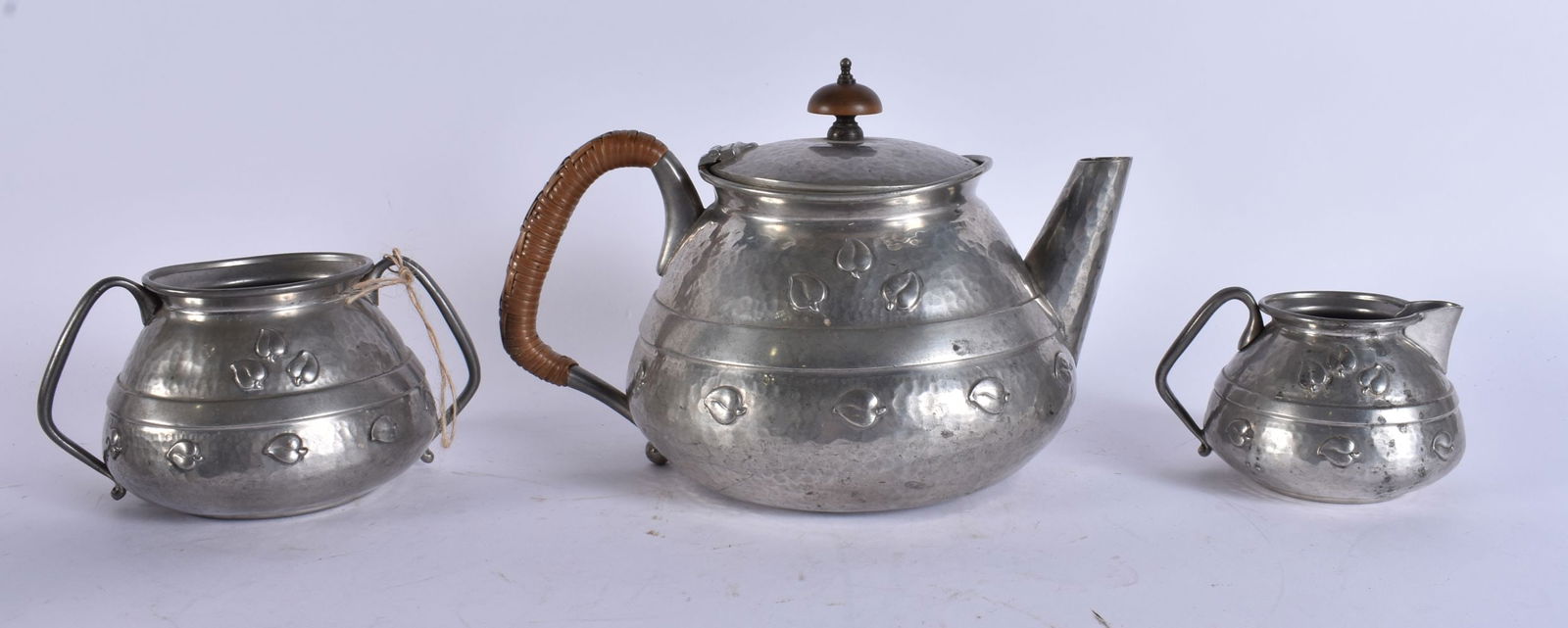AN ART DECO PEWTER HAMMERED TEASET. Largest 18 cm wide. (3) (1 of 6)
