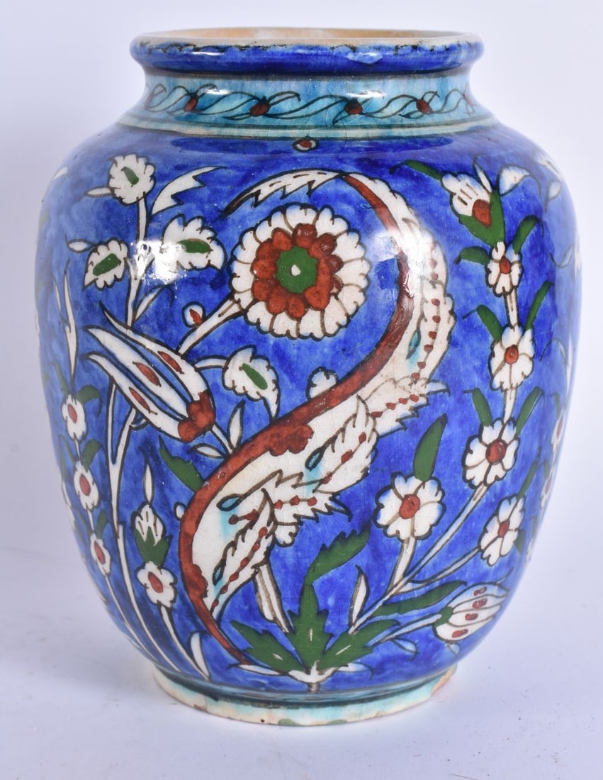 A MIDDLE EASTERN PALESTINE IZNIK POTTERY VASE painted with flowers. 18.5 cm high. (1 of 5)