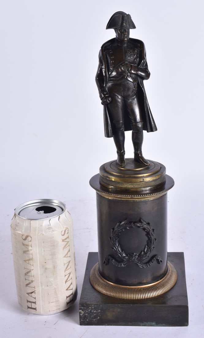 A 19TH CENTURY FRENCH NAPOLEON GRAND TOUR BRONZE FIGURE modelled upon a column wrapped in a wreath. (1 of 6)