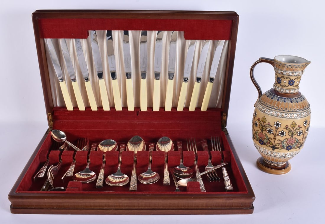 A SILVER PLATED CANTEEN together with a Mettlach jug. (qty): A SILVER PLATED CANTEEN together with a Mettlach jug. (qty)