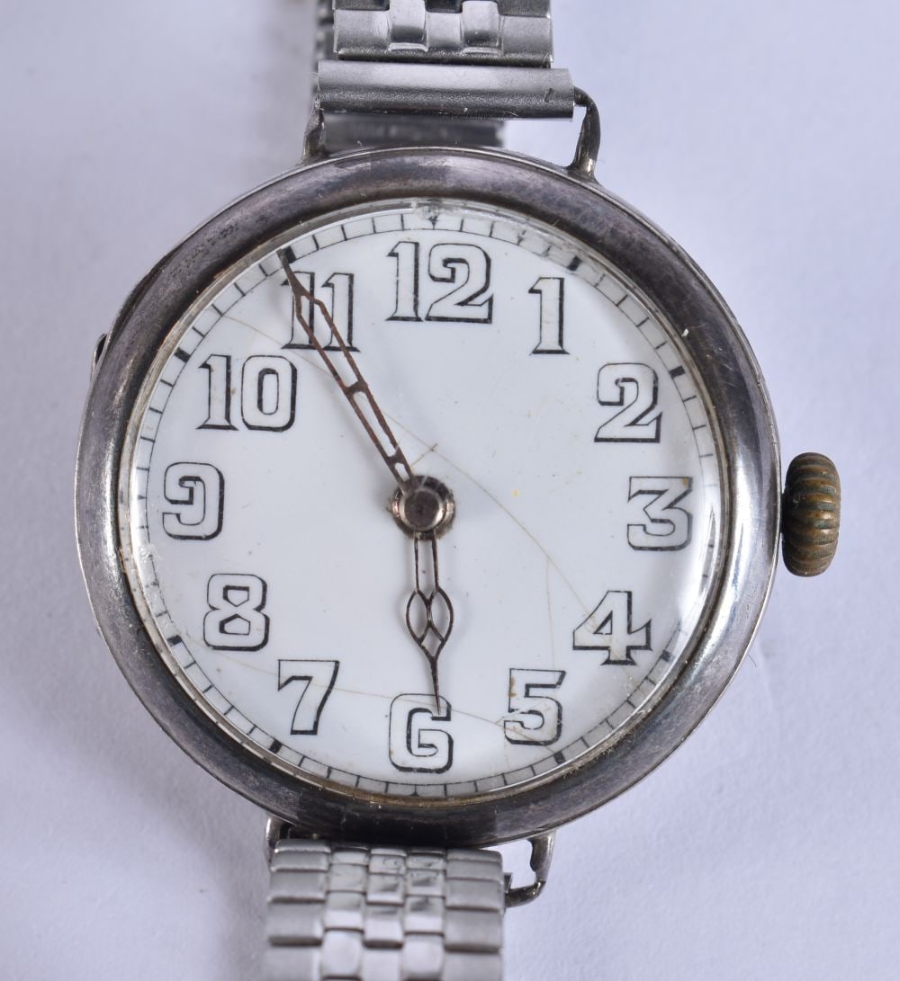 AN ANTIQUE SILVER TRENCH WATCH. Not running. 3.25 cm wide. (1 of 5)
