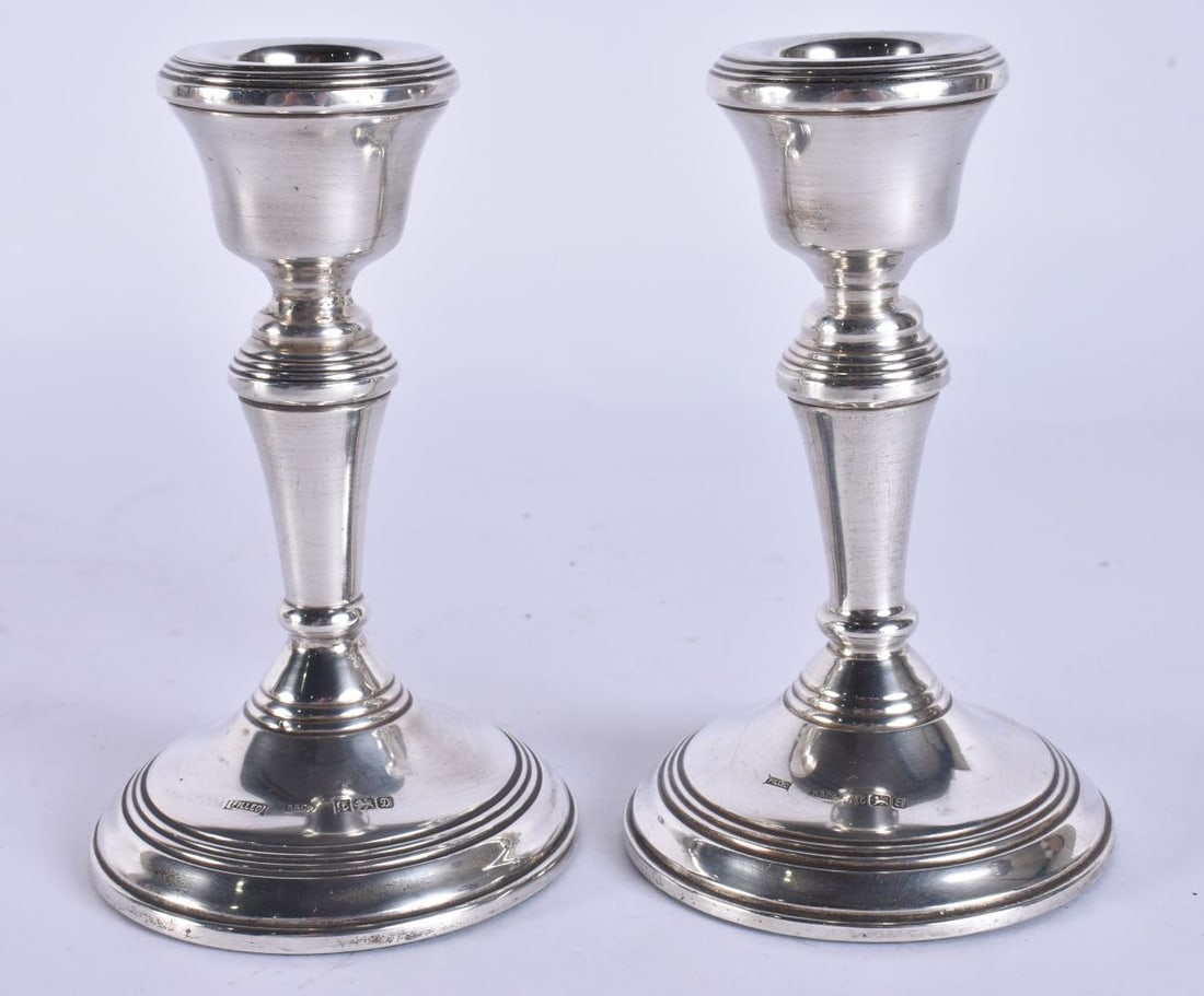 A PAIR OF CIRCULAR SILVER CANDLESTICKS. 235 grams overall. 9 cm high. (1 of 5)