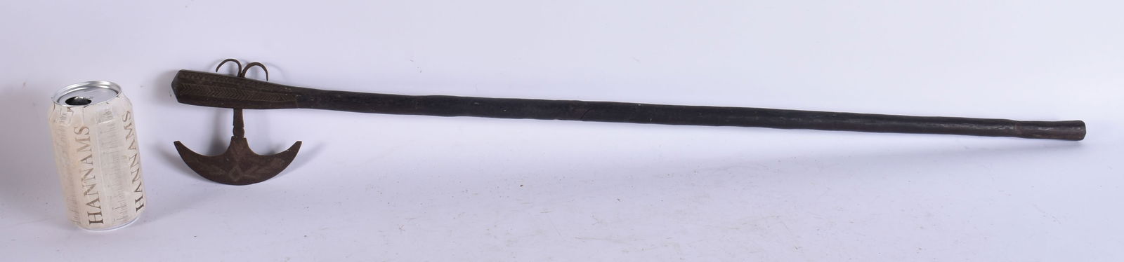 A TRIBAL CARVED WOOD AXE. 82 cm long.: A TRIBAL CARVED WOOD AXE. 82 cm long.