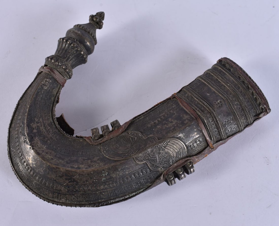 A Middle Eastern leather Jambiya dagger sheath with white metal decoration, 22 cm in length. (1 of 5)
