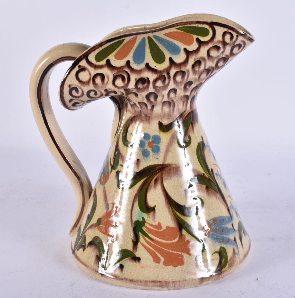 A mid 20th century studio pottery jug with hand painted decoration, 21 cm high. (1 of 5)