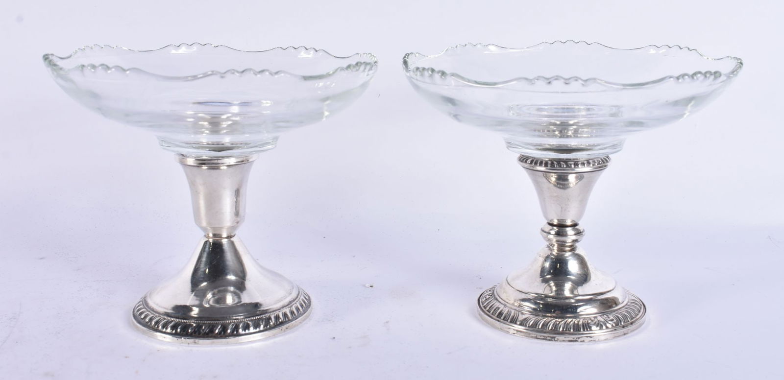 A PAIR OF SILVER CUT GLASS DISHES. 1009 grams overall. 15.5 cm wide. (1 of 4)