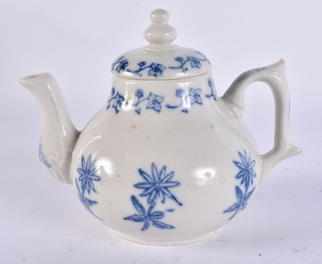 AN 18TH CENTURY SALT GLAZED POTTERY TEAPOT AND COVER painted with flowers. 14cm wide. (1 of 6)