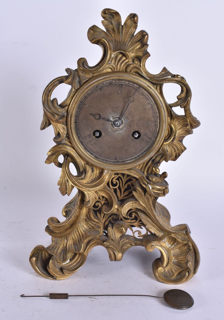 A 19TH CENTURY FRENCH ORMOLU MANTEL CLOCK with silvered dial and open work panel. 25 cm x 12 cm. (1 of 6)