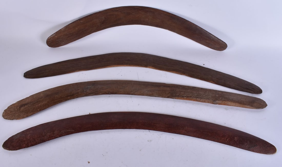 FOUR AUSTRALIAN TRIBAL ABORIGINAL CARVED WOOD BOOMERANGS. Largest 62 cm wide. (4): FOUR AUSTRALIAN TRIBAL ABORIGINAL CARVED WOOD BOOMERANGS. Largest 62 cm wide. (4)
