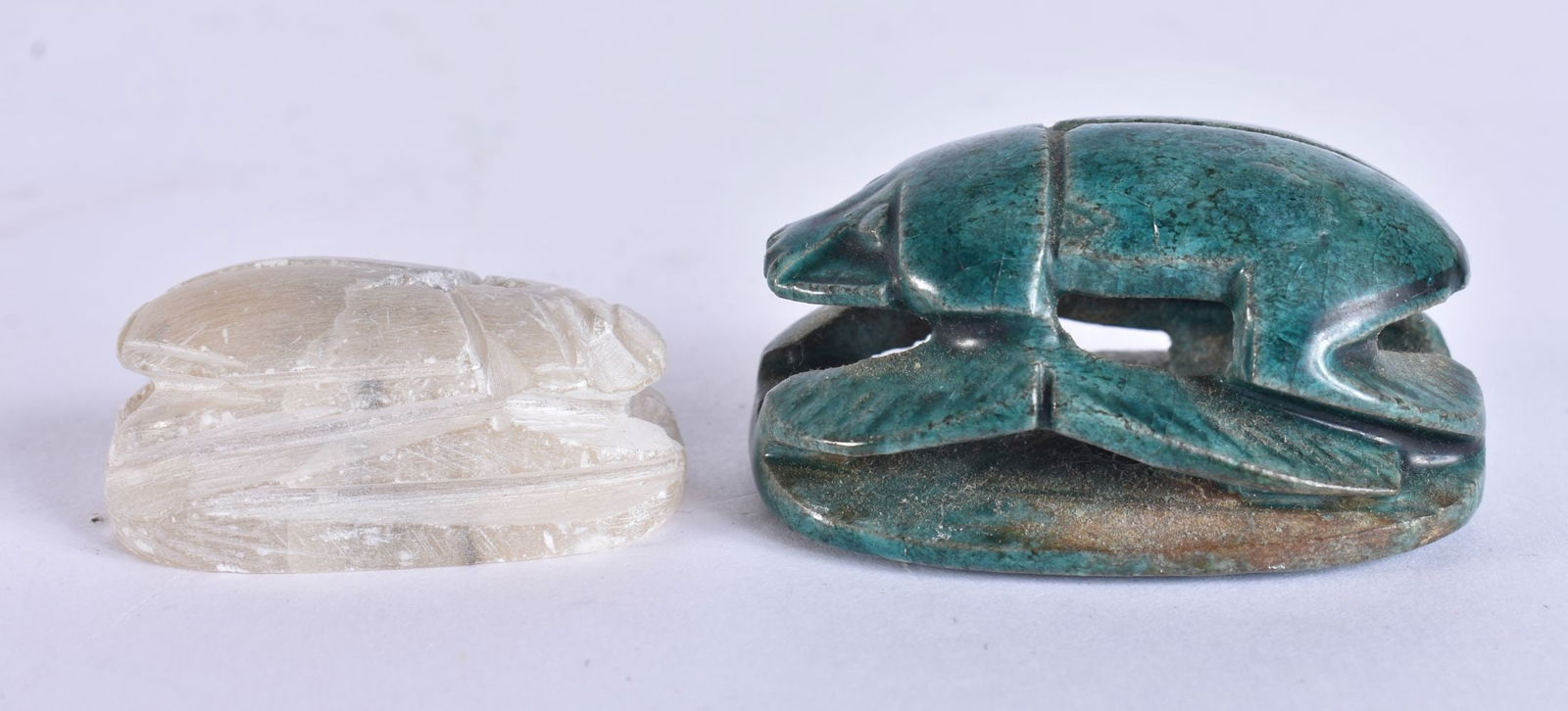 A 19TH CENTURY EGYPTIAN GRAND TOUR FAIENCE GLAZED SCARAB BEETLE together with another. Largest 5 cm: A 19TH CENTURY EGYPTIAN GRAND TOUR FAIENCE GLAZED SCARAB BEETLE together with another. Largest 5 cm wide. (2)